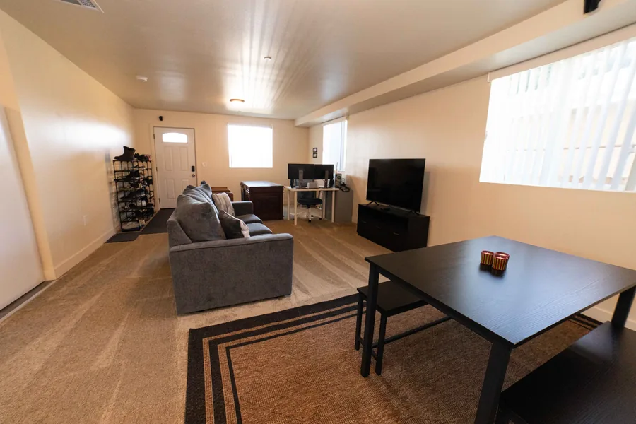 Common room with a sofa, a television and a dining table