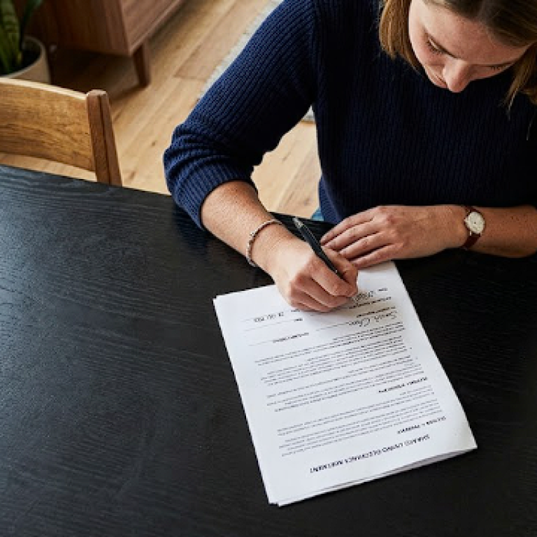 Resident signing agreement to a no credit check housing room in Los Angeles.
